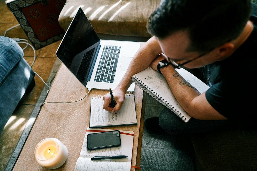 writer at desk with notes