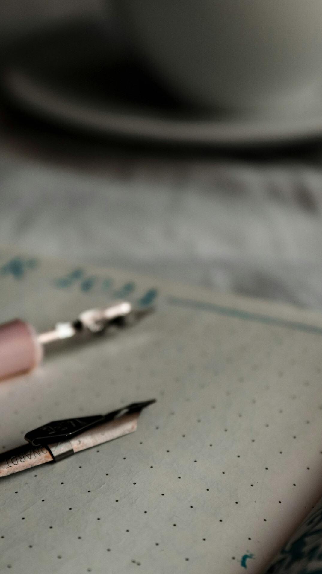 Close-up of a hand writing in a notebook with a fountain pen