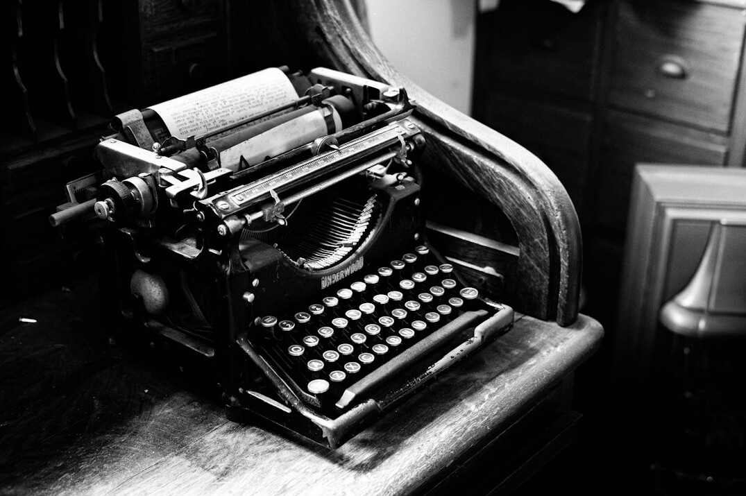writer typing on typewriter